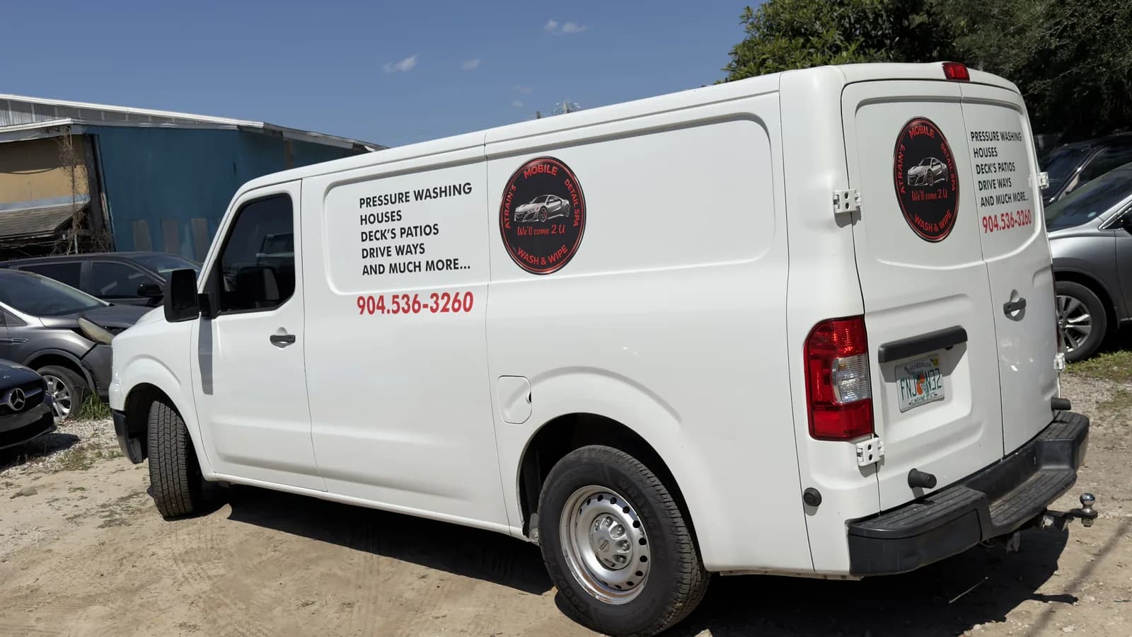 White cargo van with door decals for a pressure washing company in Jacksonville