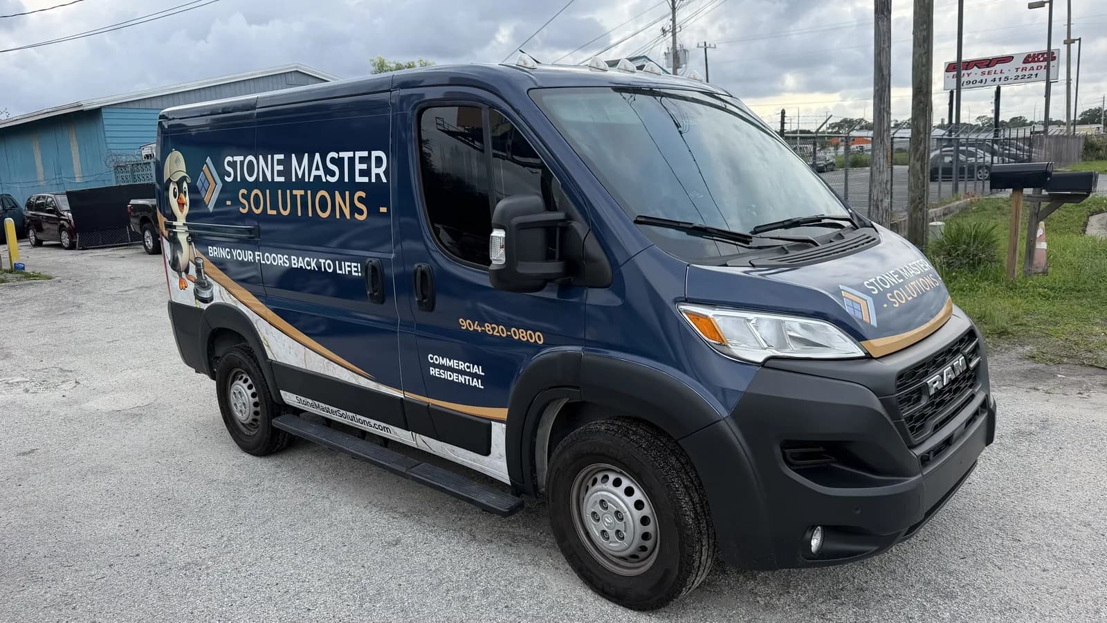 Side of a cargo van wrapped for a stone and remodeling company