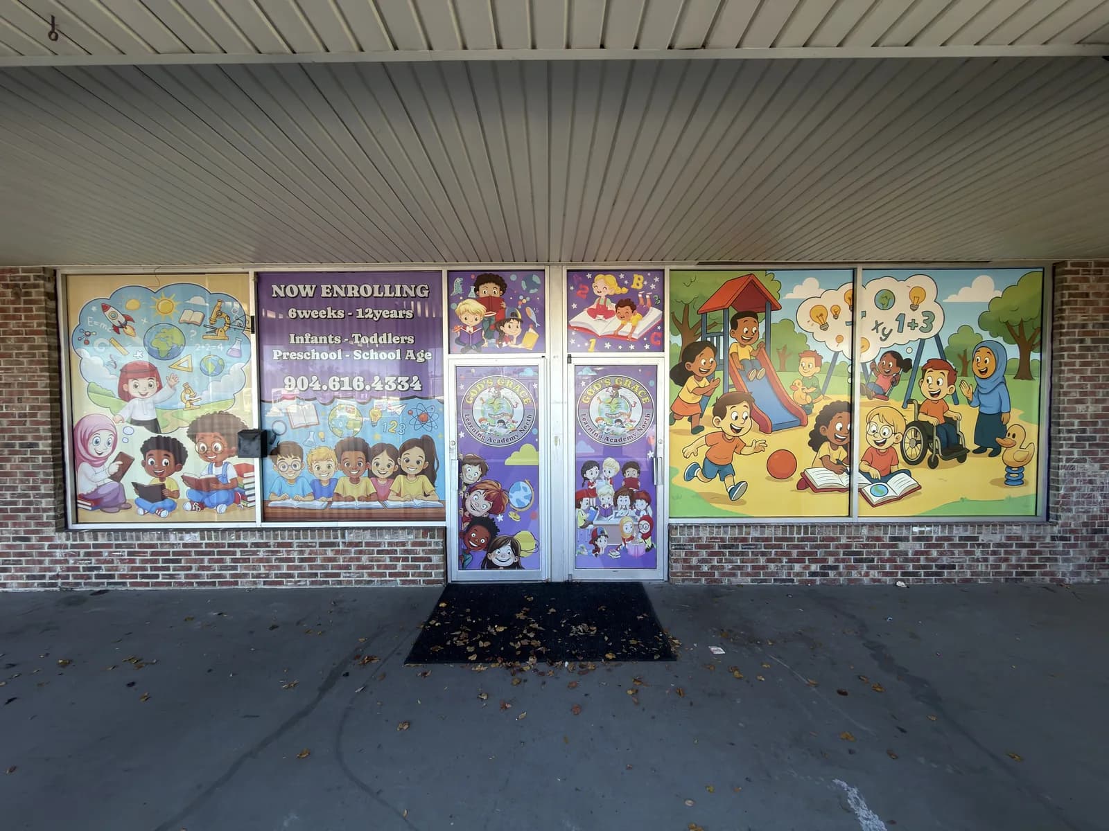 School windows with printed illustrations along the front of the building