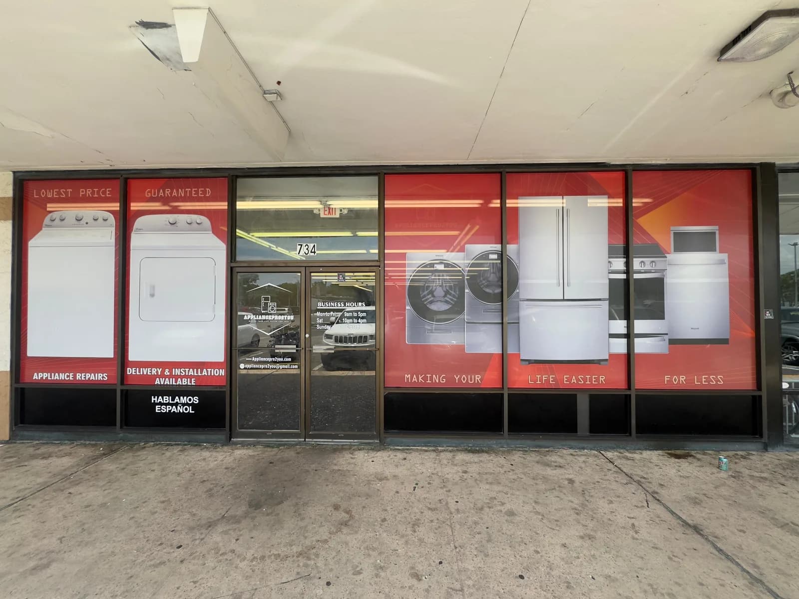 Appliance store windows with printed product graphics
